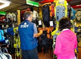 two people looking at backpacks