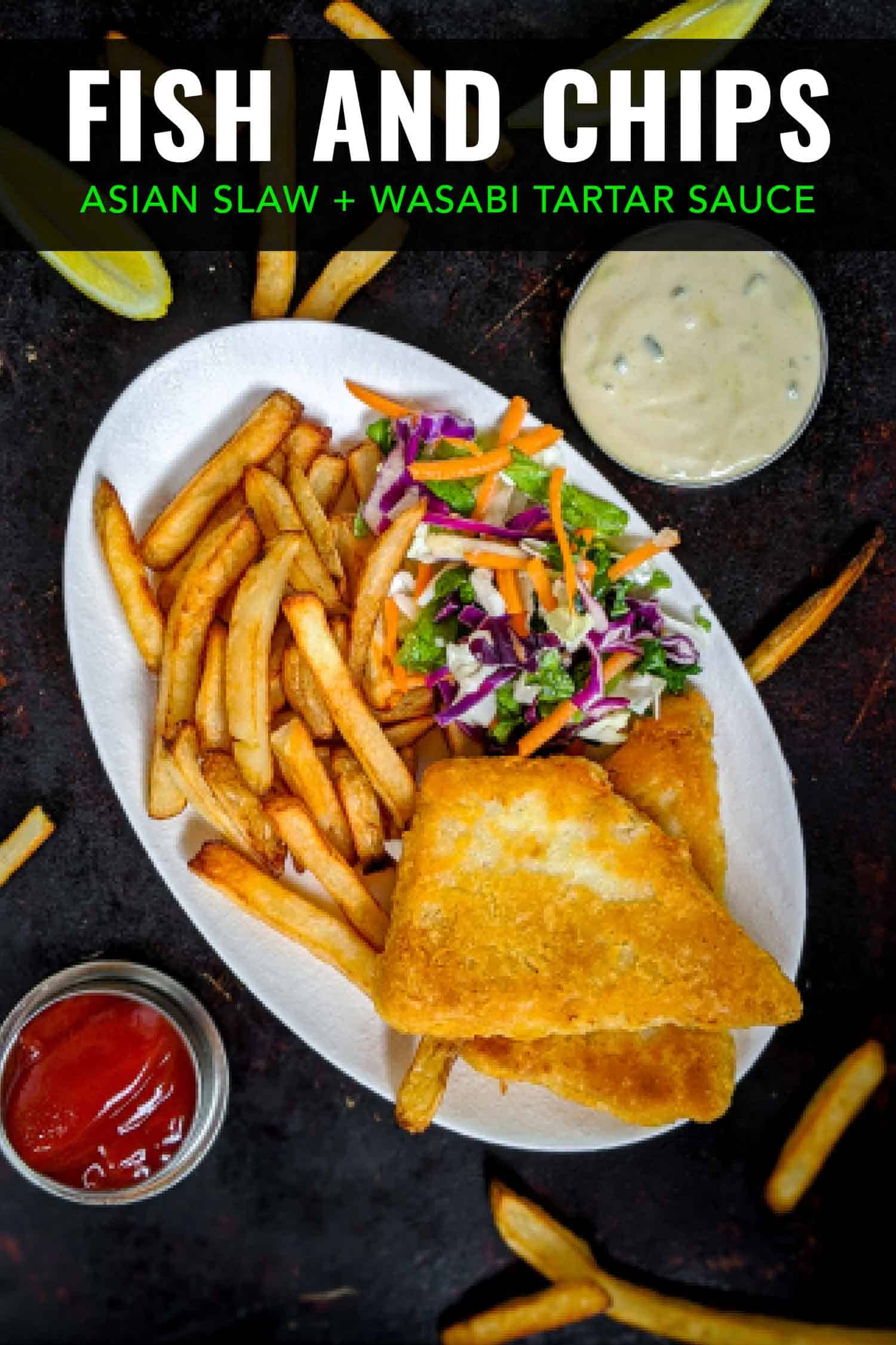 Fish and chips on a white plate with ketchup and tartar sauce