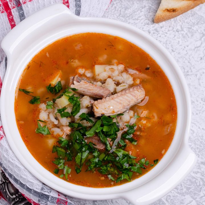 Peruvian fish soup called sudado in a white bowl.