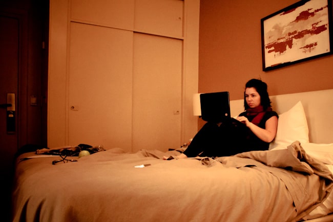 girl in hotel room on laptop