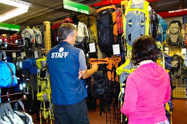 two people looking at backpacks