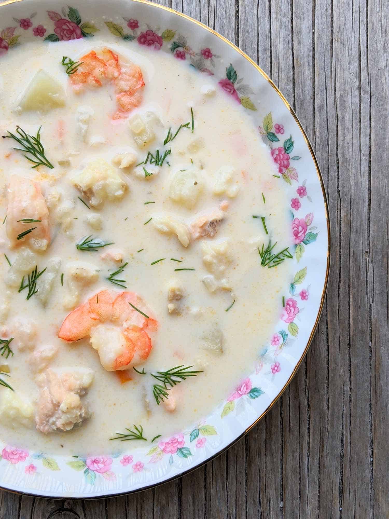 Nova Scotia chowder in a vintage bowl on a wooden background.