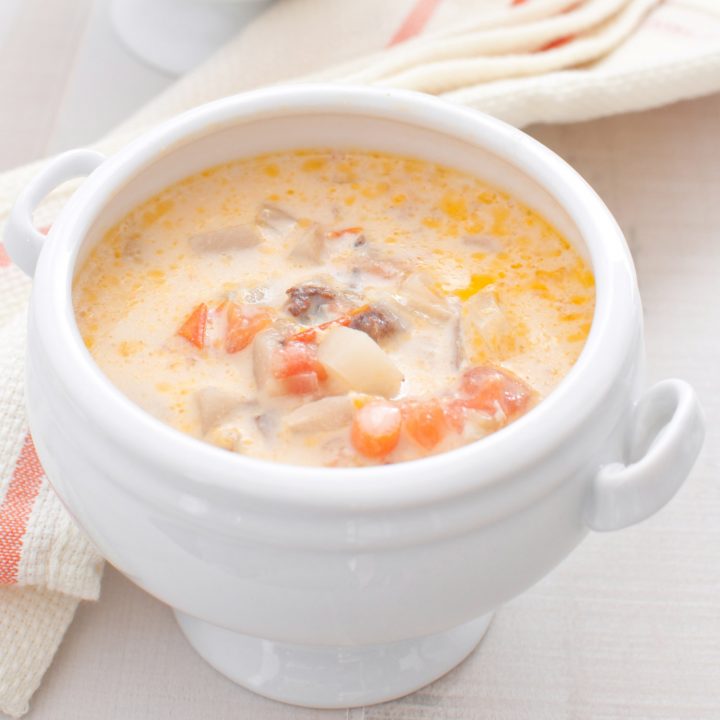 Nova Scotia seafood chowder with cream in a white bowl.