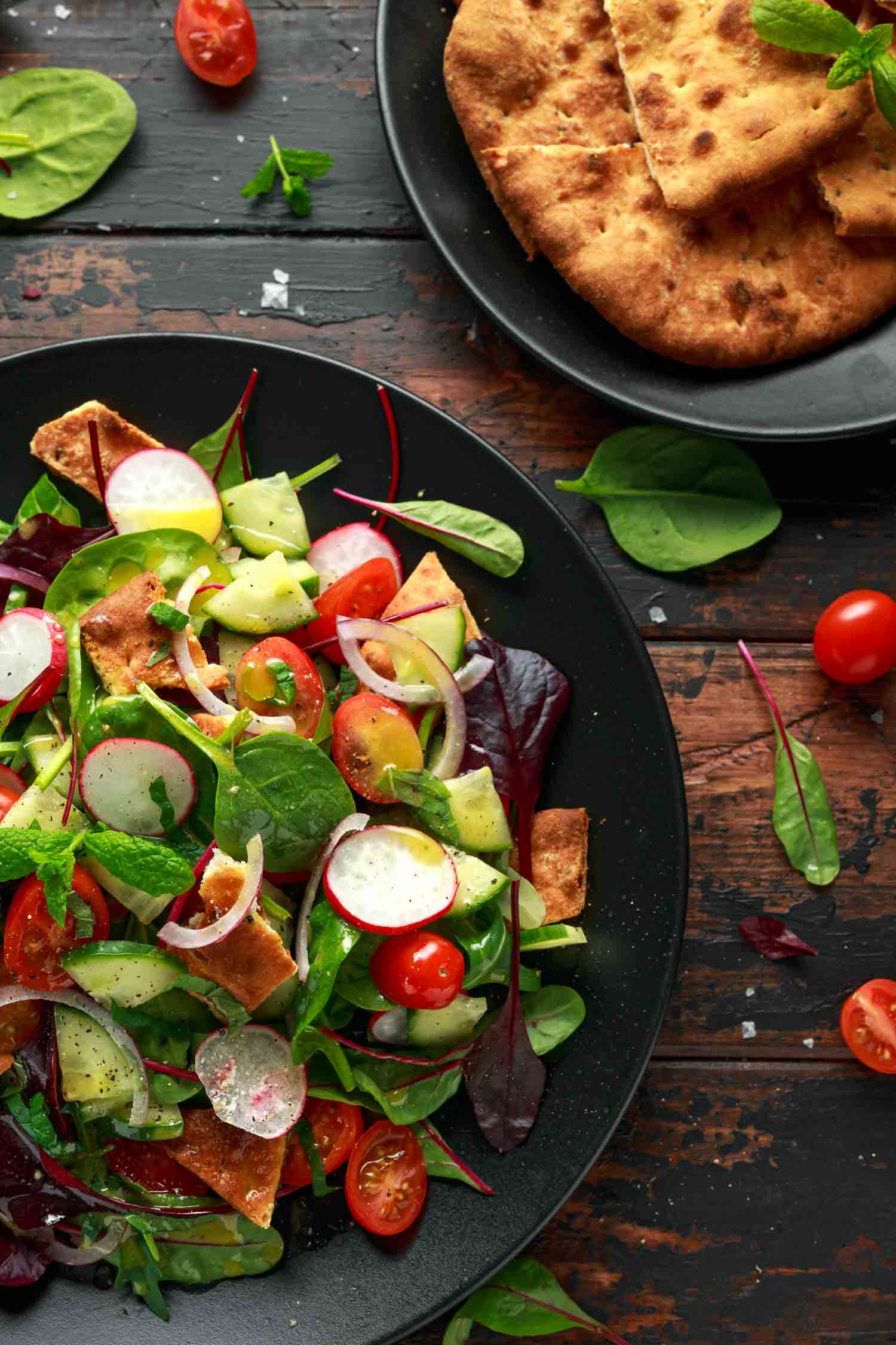 Traditional cuisine in Jordan fattoush salad on a plate with pita croutons, cucumber, tomato, red onion, vegetables mix and herbs