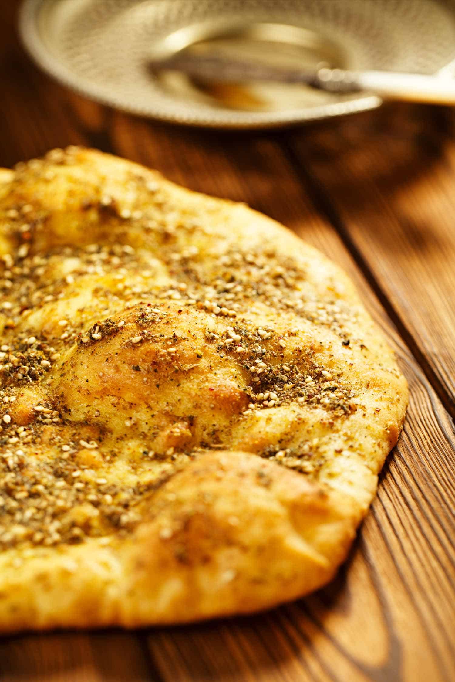 Jordanian spice Zaatar on Manakish spice mix with naan bread - traditional Middle Eastern blend made with thyme, sesame seeds, salt, sumac, oregano, cumin, fennel seeds and marjoram