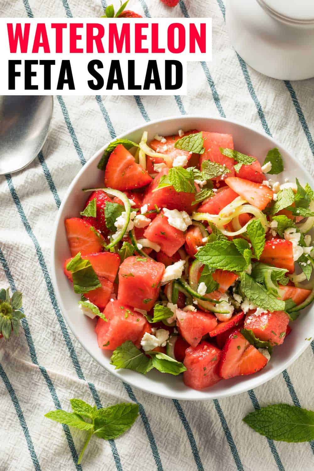 Watermelon feta mint salad in a bowl on a tea towel.