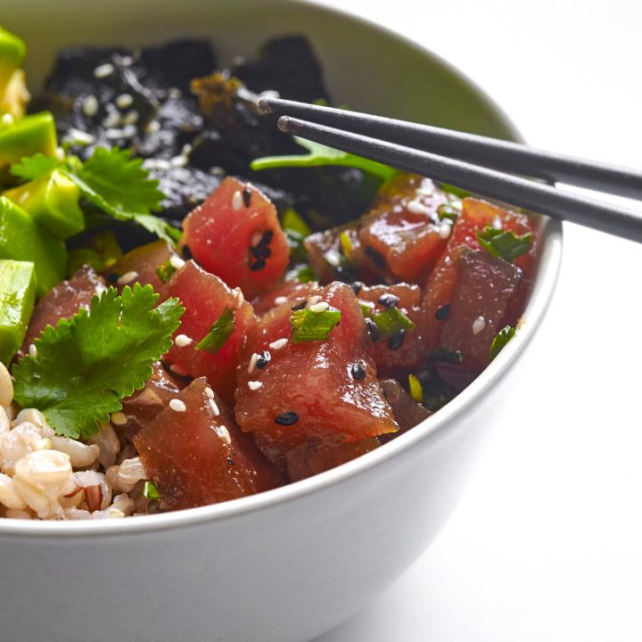 Hawaiian poke in white bowl with chopsticks