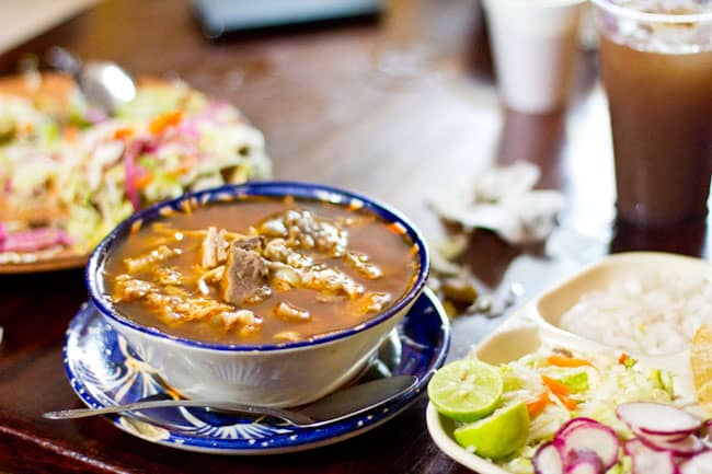 How to make pozole or posole. This Mexican pork stew is perfect to make for Cinco de Mayo. You can make it ahead of time for barbecues and picnics.