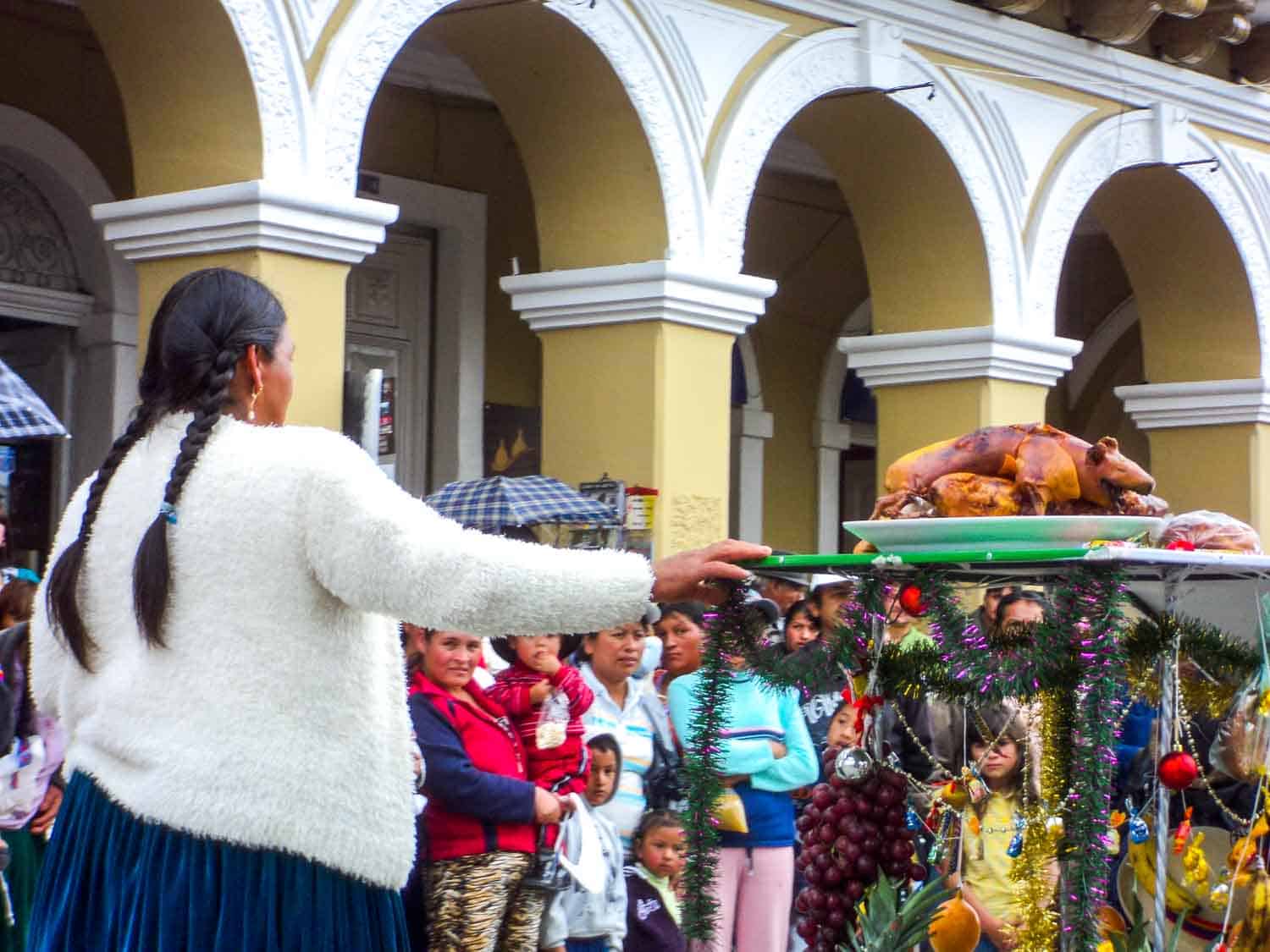 Offering of cuy at Pase del Niño Viajero parade in Cuenca Ecuador