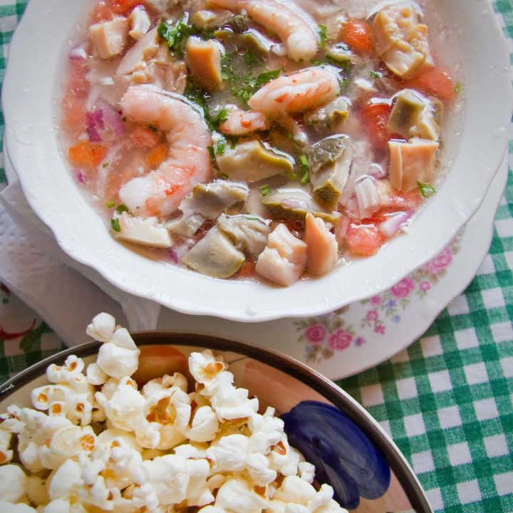Ecuadorian ceviche with shrimp and served next to popcorn.