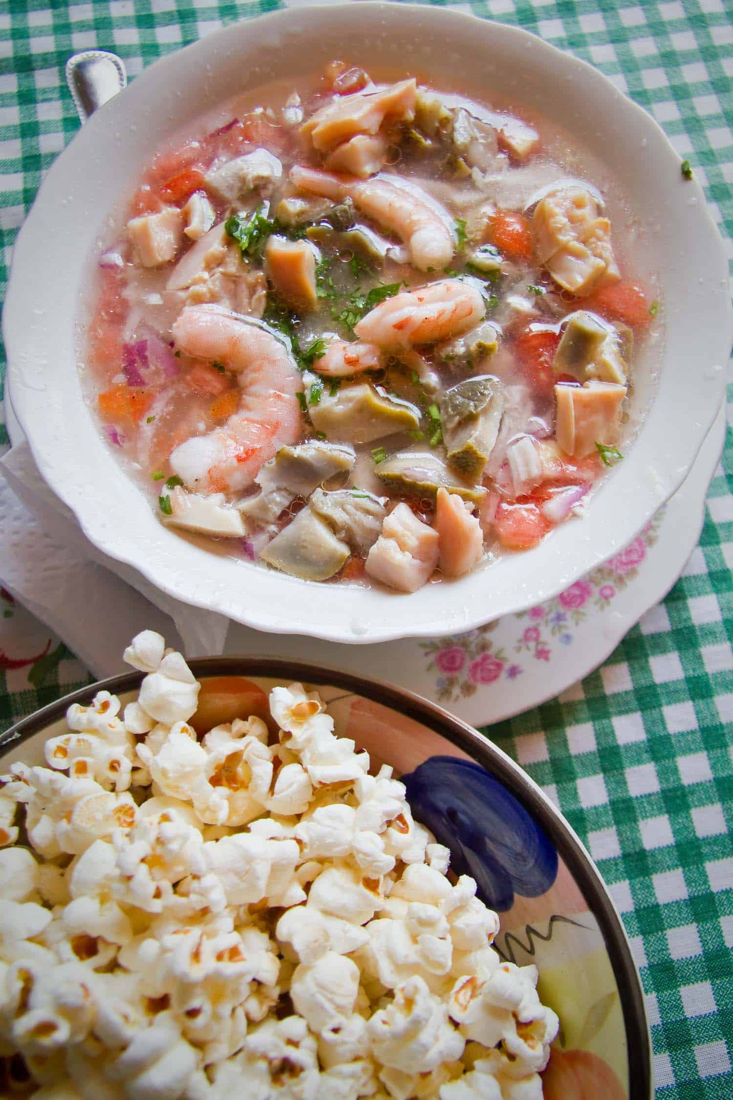 Ecuadorian ceviche with shrimp and served next to popcorn.