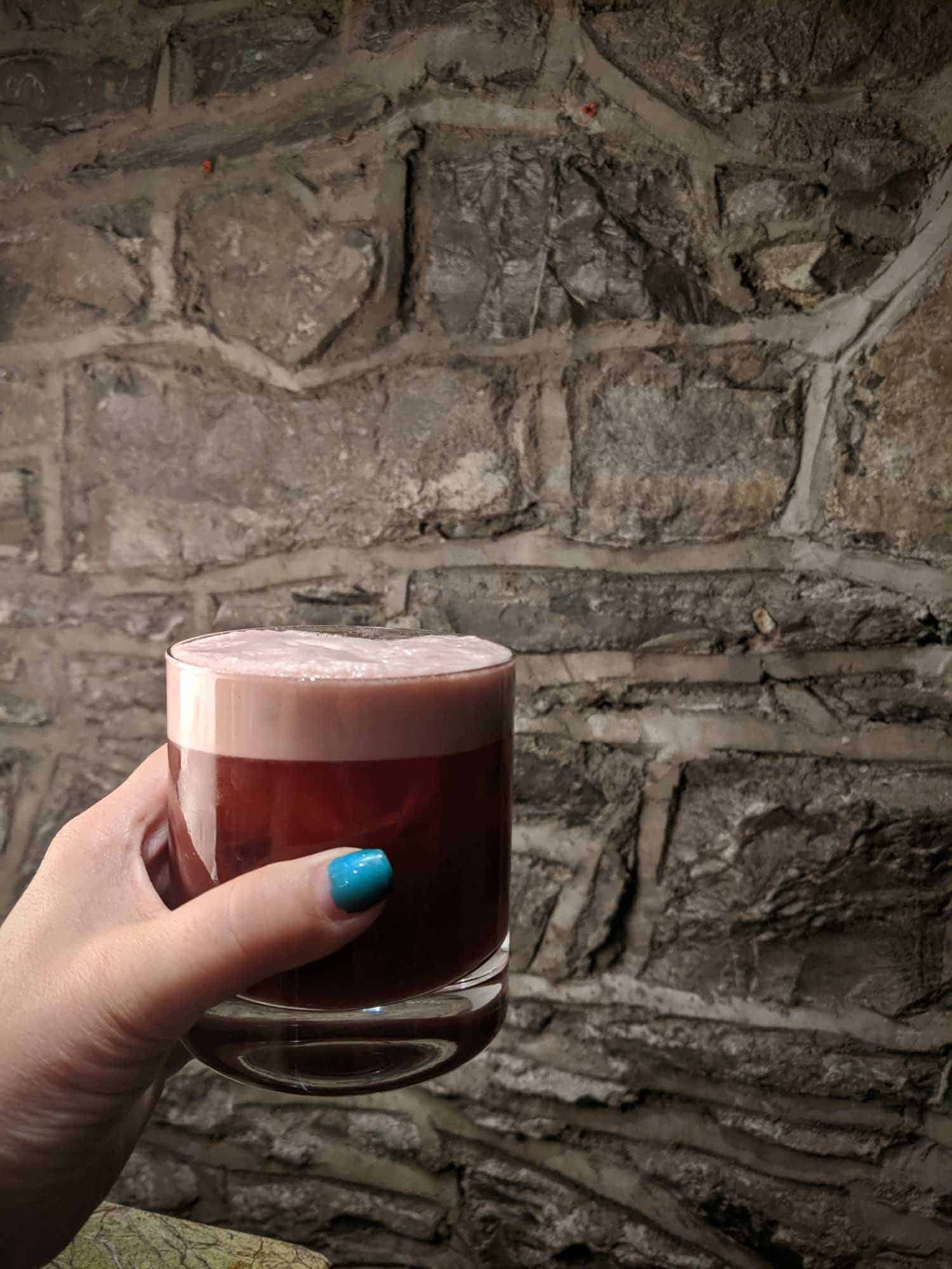 Beet cocktail in a woman's hand in a Dublin restaurant