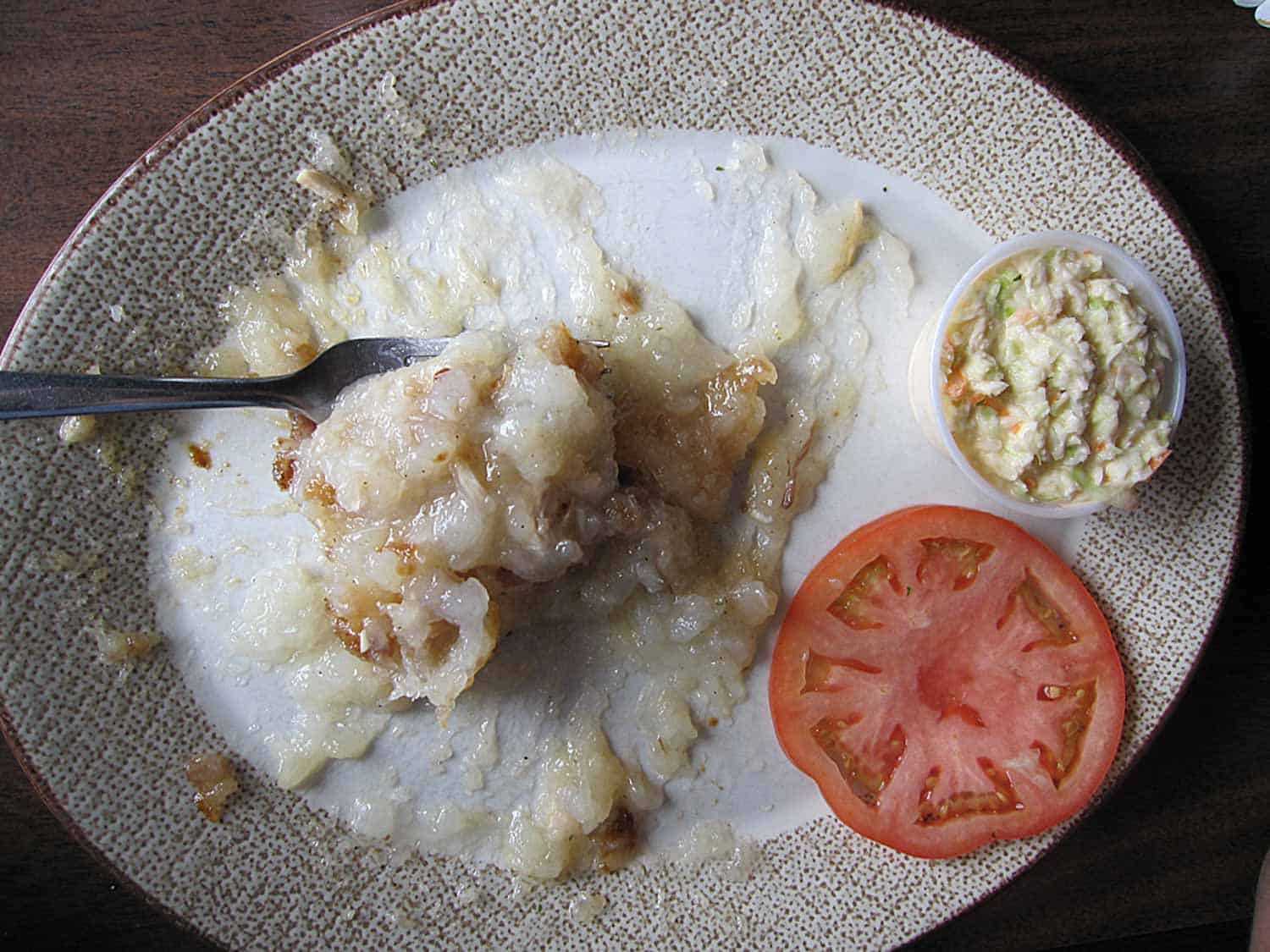 Canadian rappie pie on a plate with tomato and coleslaw