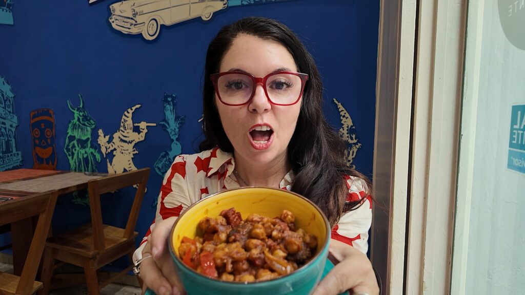 Ayngelina holding a bowl of garbanzos fritos at Donde Lis restaurant in Havana Cuba
