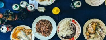 Plates of traditional Cuban food on a blue tablecloth at a restaurant in Havana