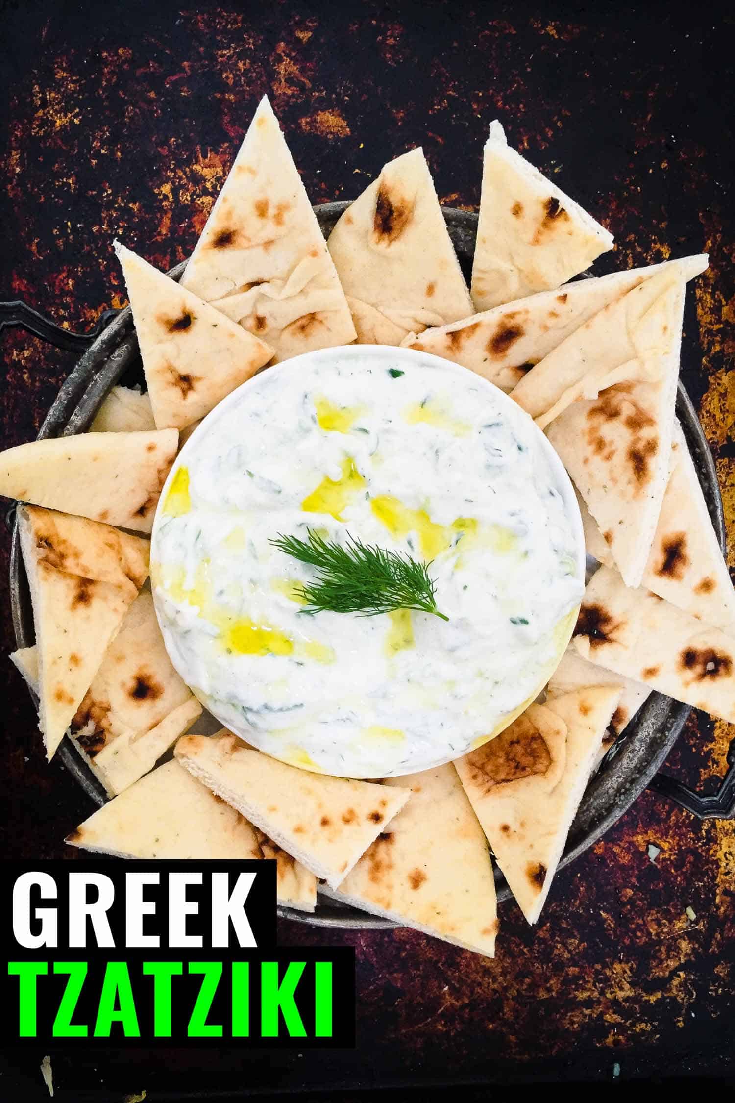 Tzatziki with pita bread on a rustic background
