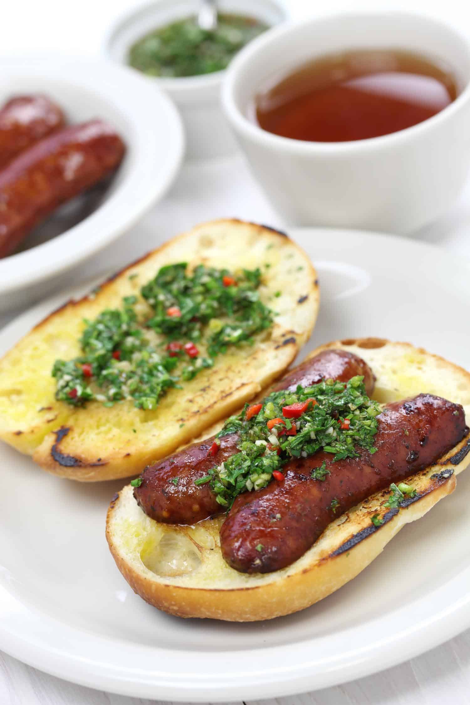 Chimichurri on choripan at at Argentinean asado.