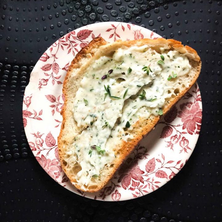 Pesto modenese on a piece of bread, cured pork fat whipped with rosemary and garlic.