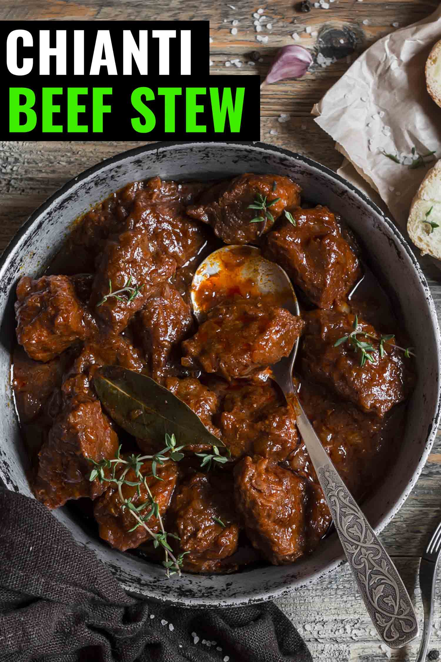 Chianti beef stew, beef braised in red wine in a rustic looking pot on a grey background