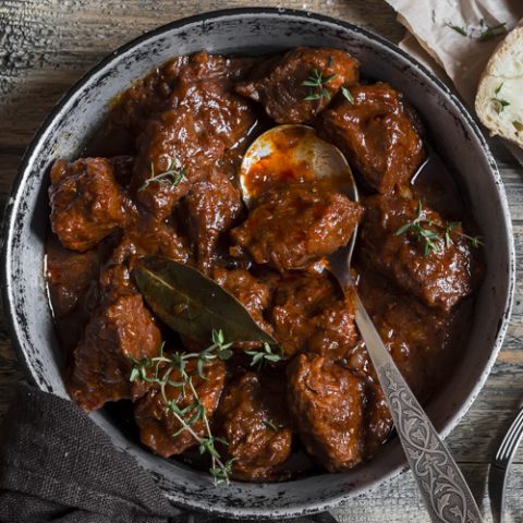 Red wine beef stew in a rustic setting