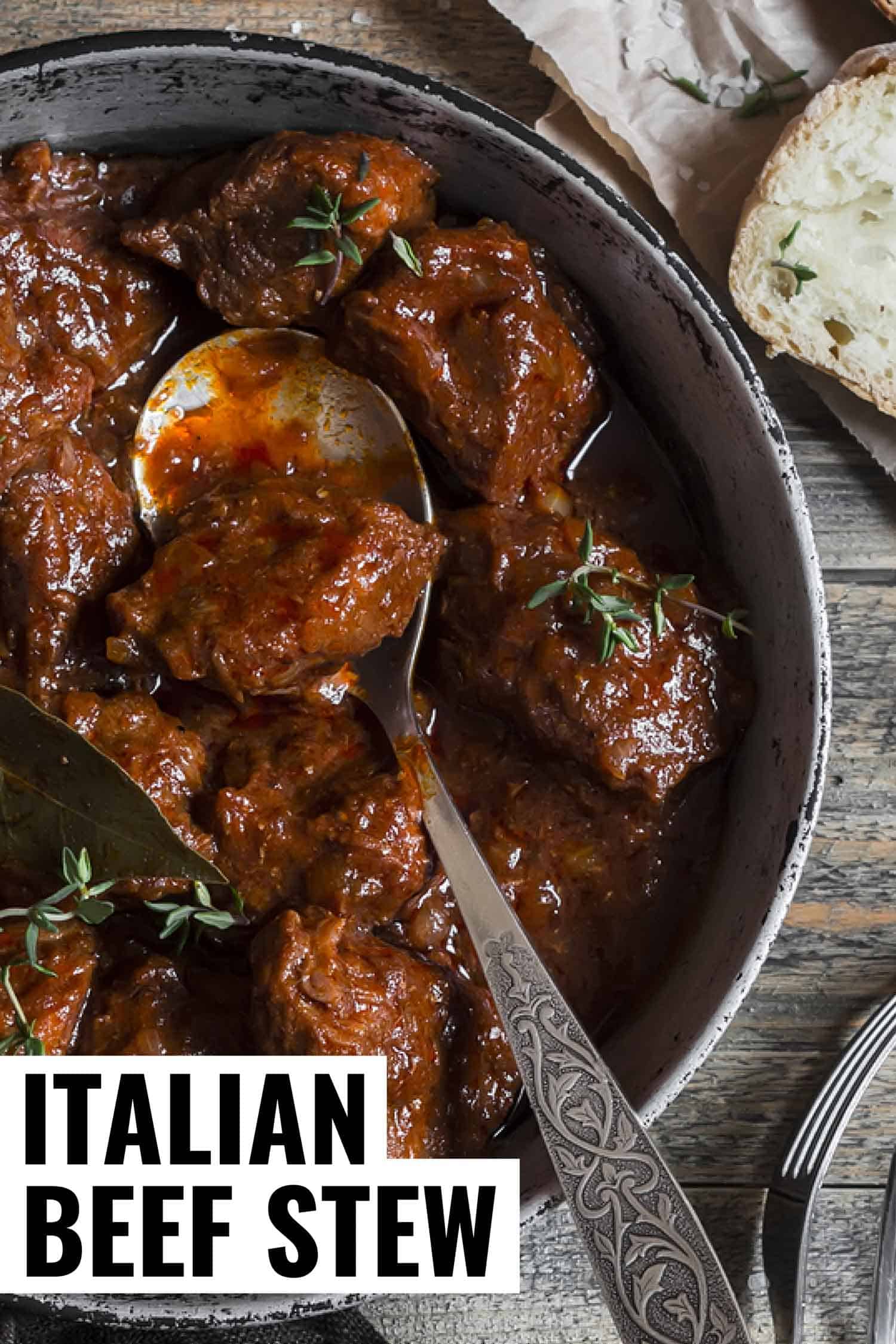 Italian beef stew braised in red wine in a grey pot on a grey rustic background