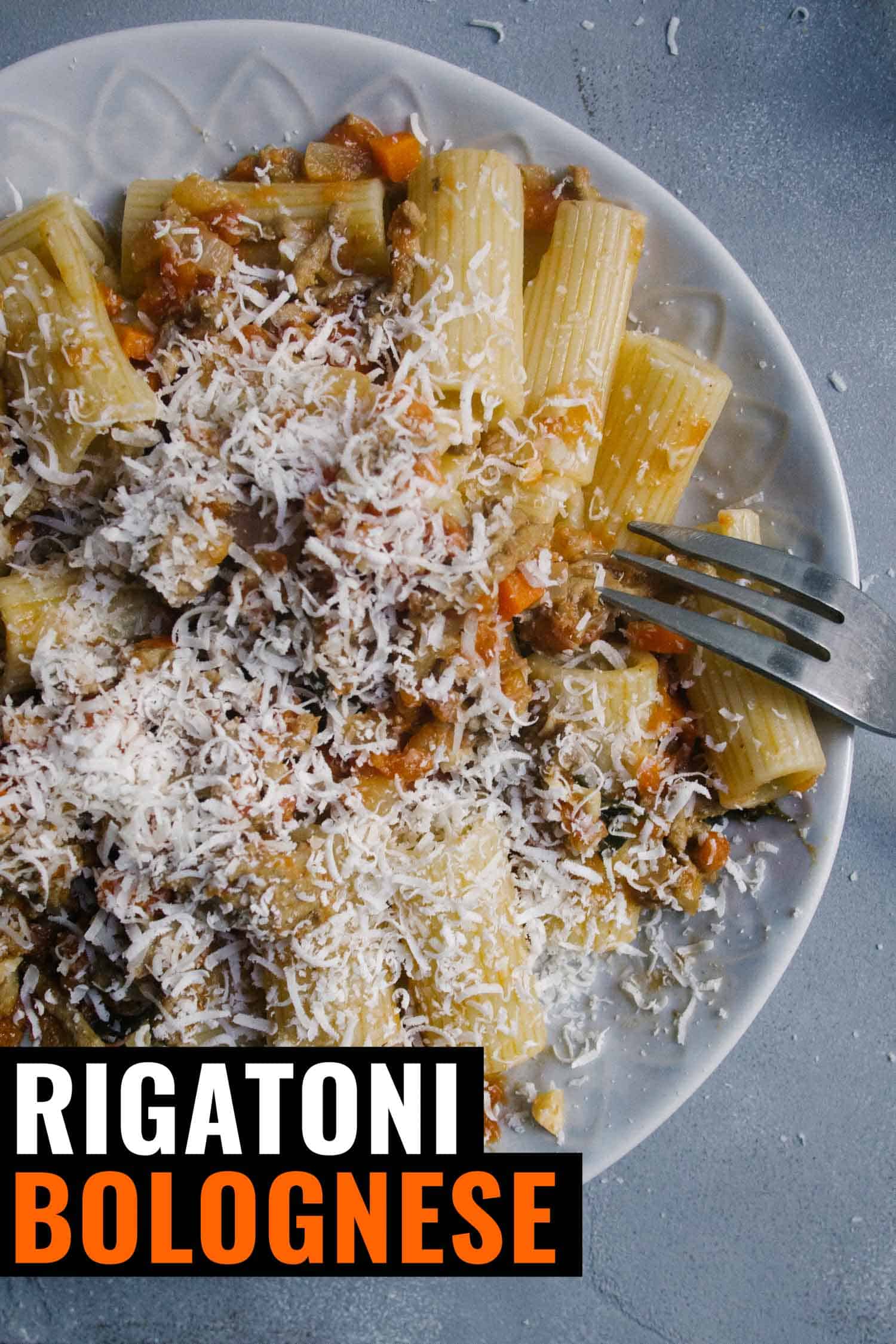 Rigatoni with a bolognese sauce on a blue background
