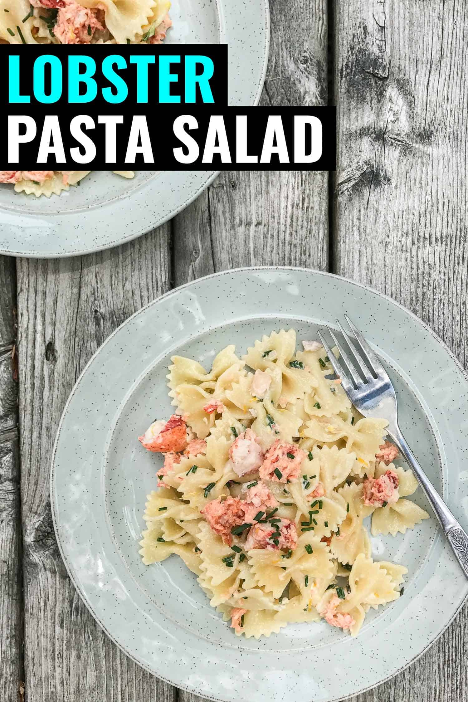 lobster pasta salad with bowtie pasta and a lobster claw on a blue plate