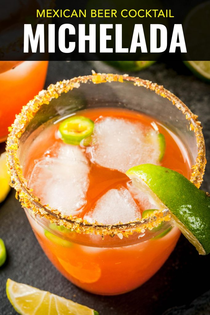 Michelada beer cocktail on a table with limes.