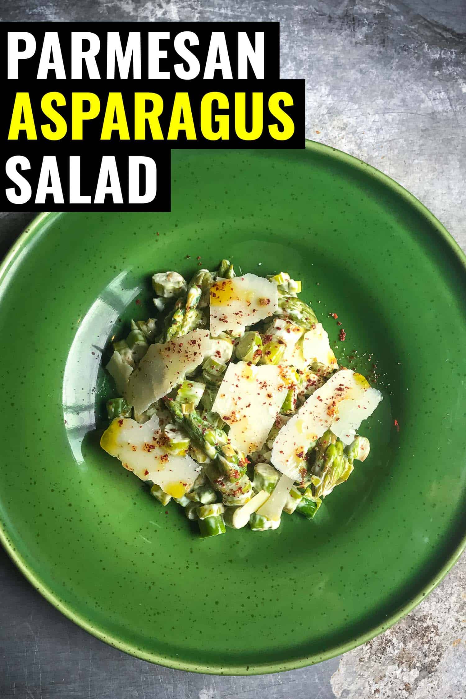 Parmesan asparagus salad on a green plate