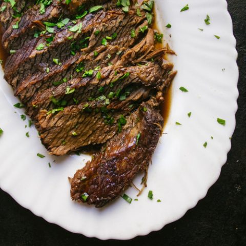 sliced brisket with parsley garnished with parsley