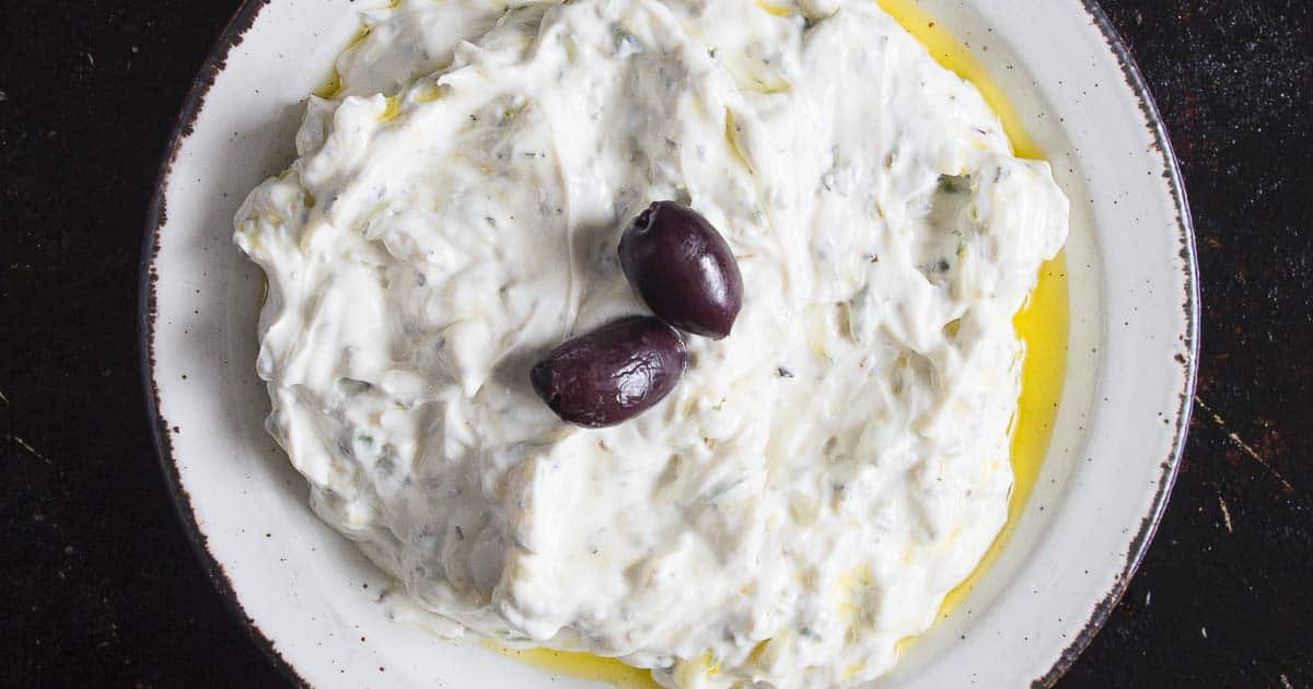 turkish cacik on a white plate and dark background.