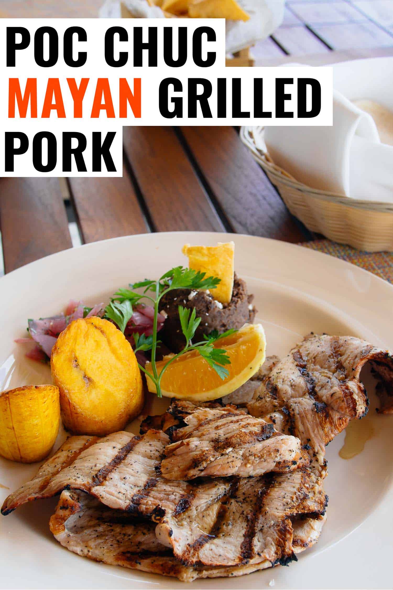 Poc chuc Mayan recipe of grilled pork on a plate with potatoes and greens