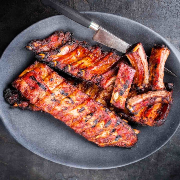 Instant pot barbecue spare ribs St Louis cut with hot honey chili marinade as top view on a modern design cast iron pan.