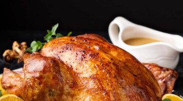 turkey cooked in instant pot on table with side dishes for thanksgiving