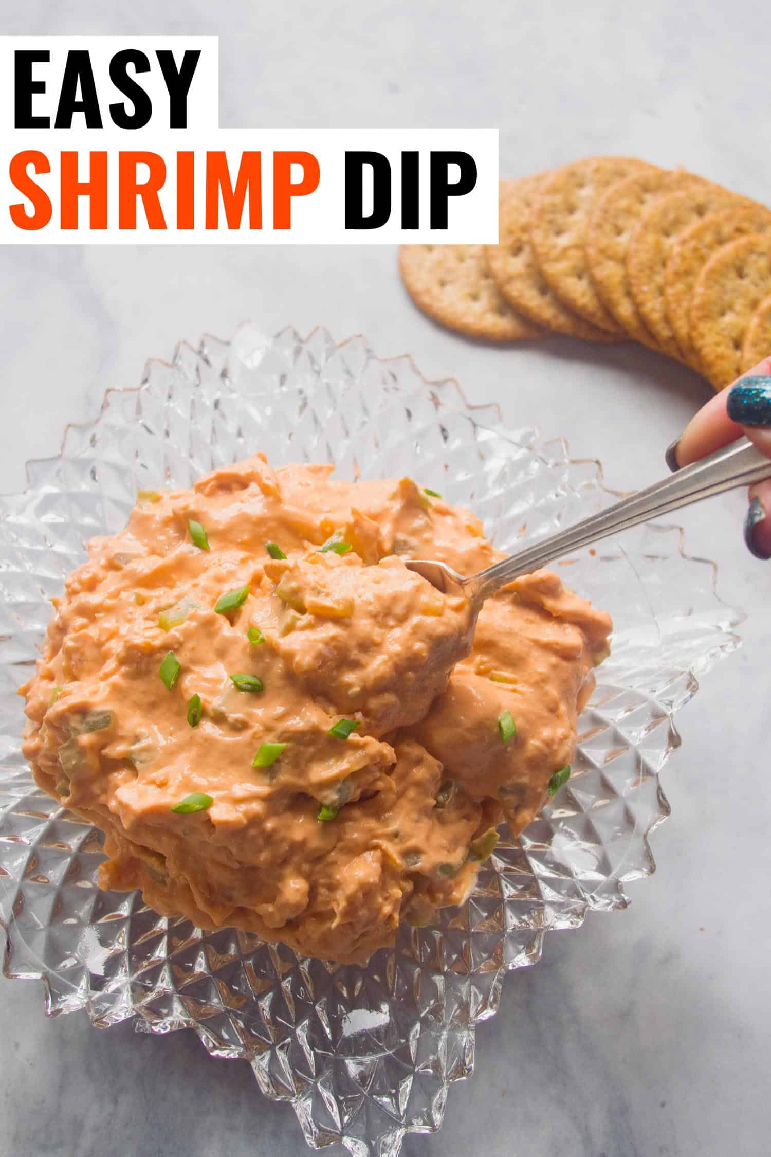Cold tomato soup shrimp dip in a crystal bowl and crackers