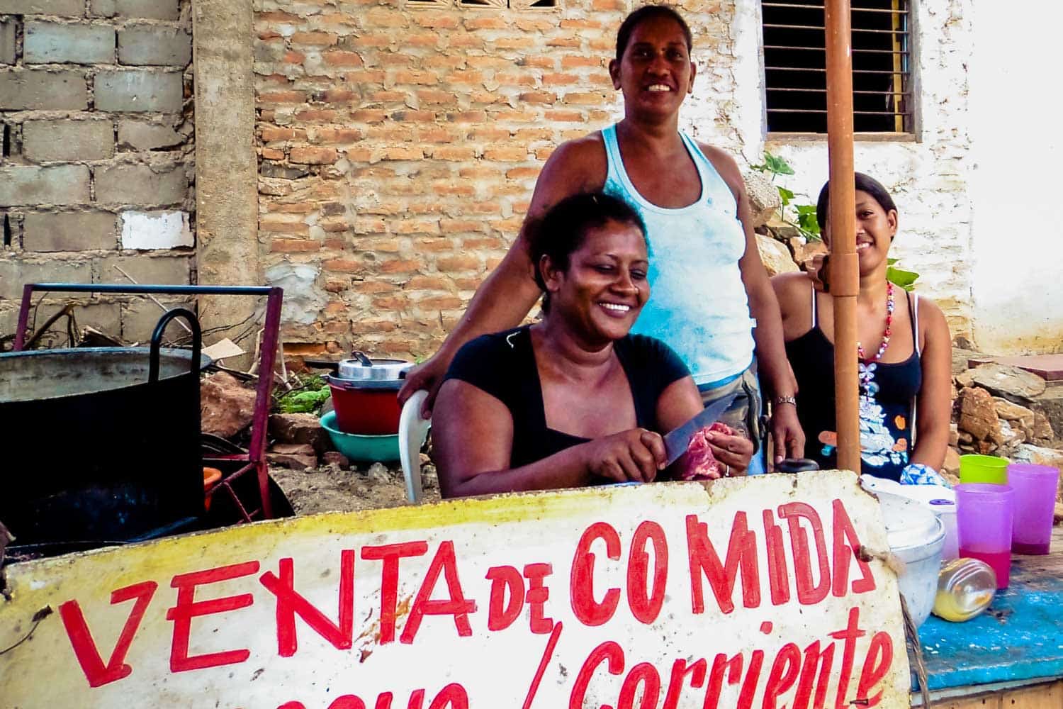 Street vendors serving traditional Colombian food in Santa Marta on the cost.