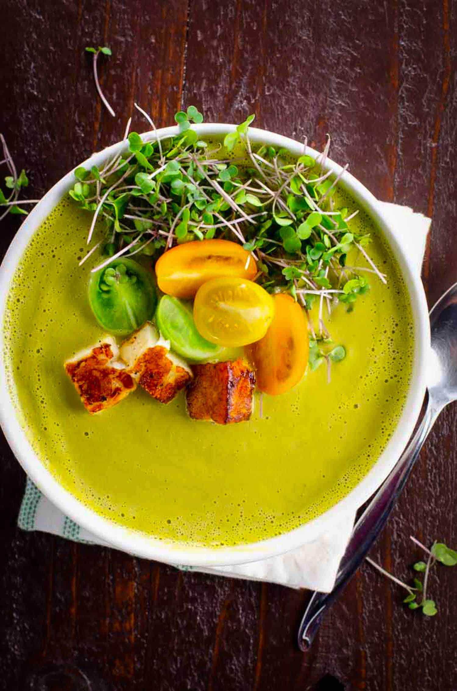 Popular ramps recipes asparagus ramp soup garnished with tomato and pea shoots on a wooden background