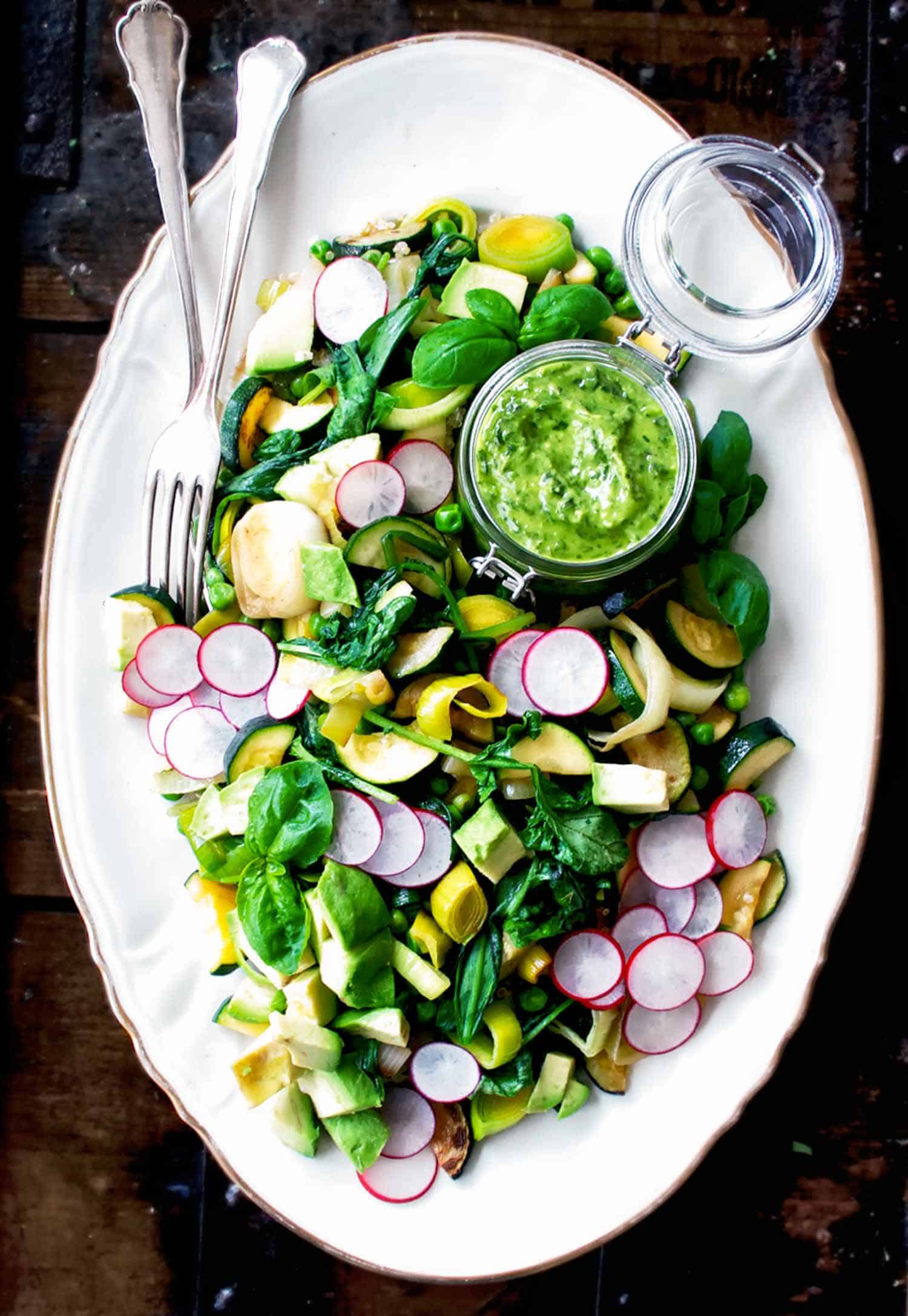 Spring Greens Salad with Wild Garlic on white plate and black background