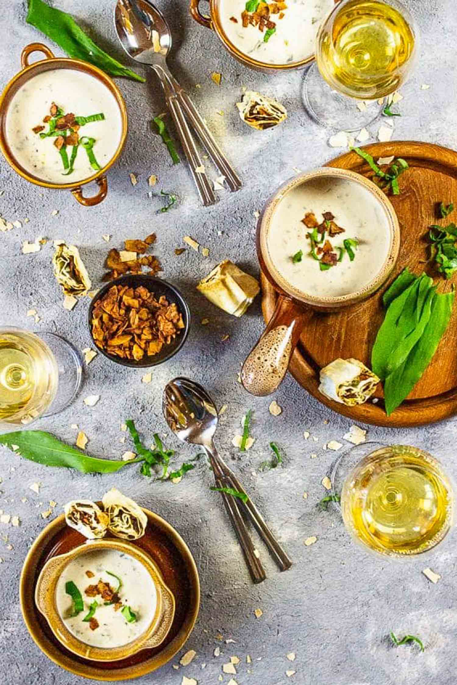 Table top shot of ramps recipe with wild garlic soup in brown bowls on a grey background