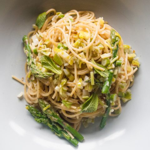 asparagus pasta in a bowl with lemon cream and leek