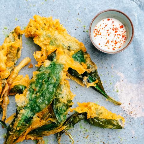 Beer battered ramps on parchment paper with dipping sauce