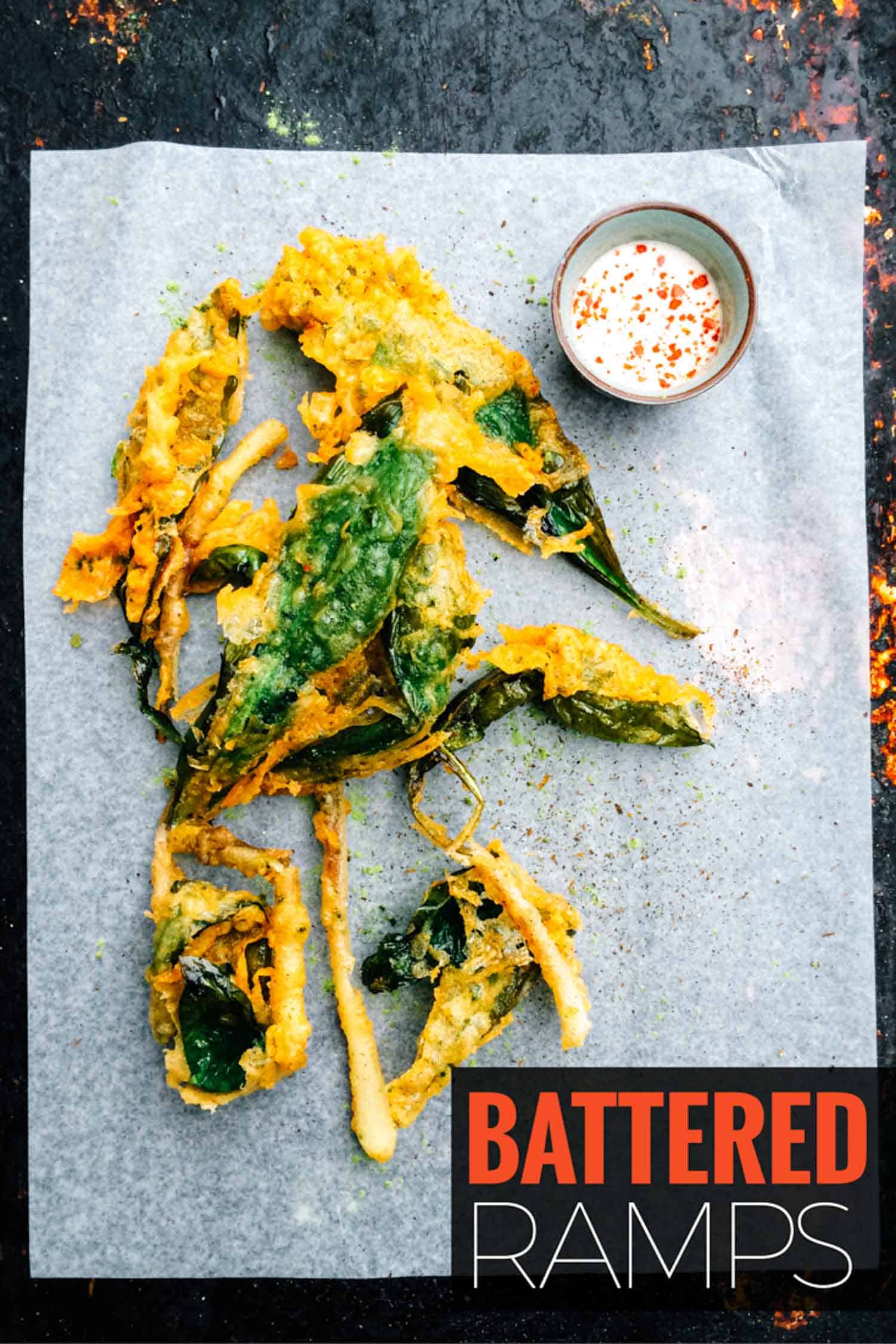 Beer battered ramps on parchment paper with dipping sauce