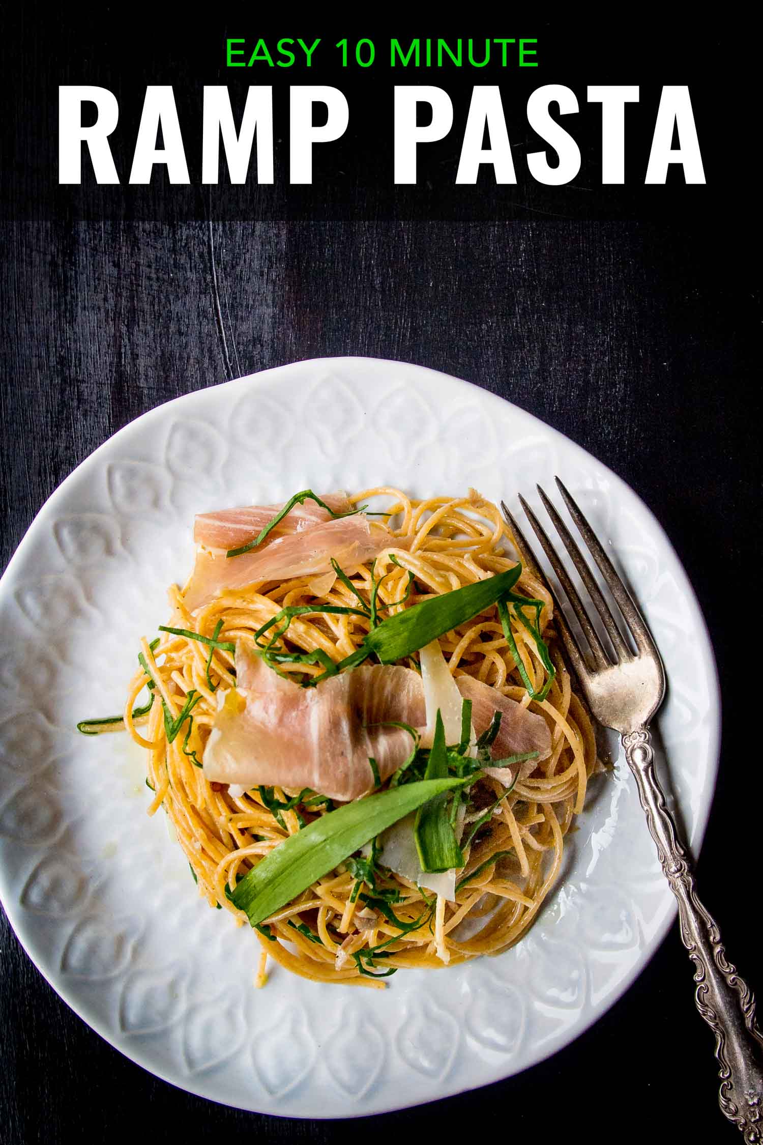 ramp pasta with prosciutto and parmesan on a white plate with a fork