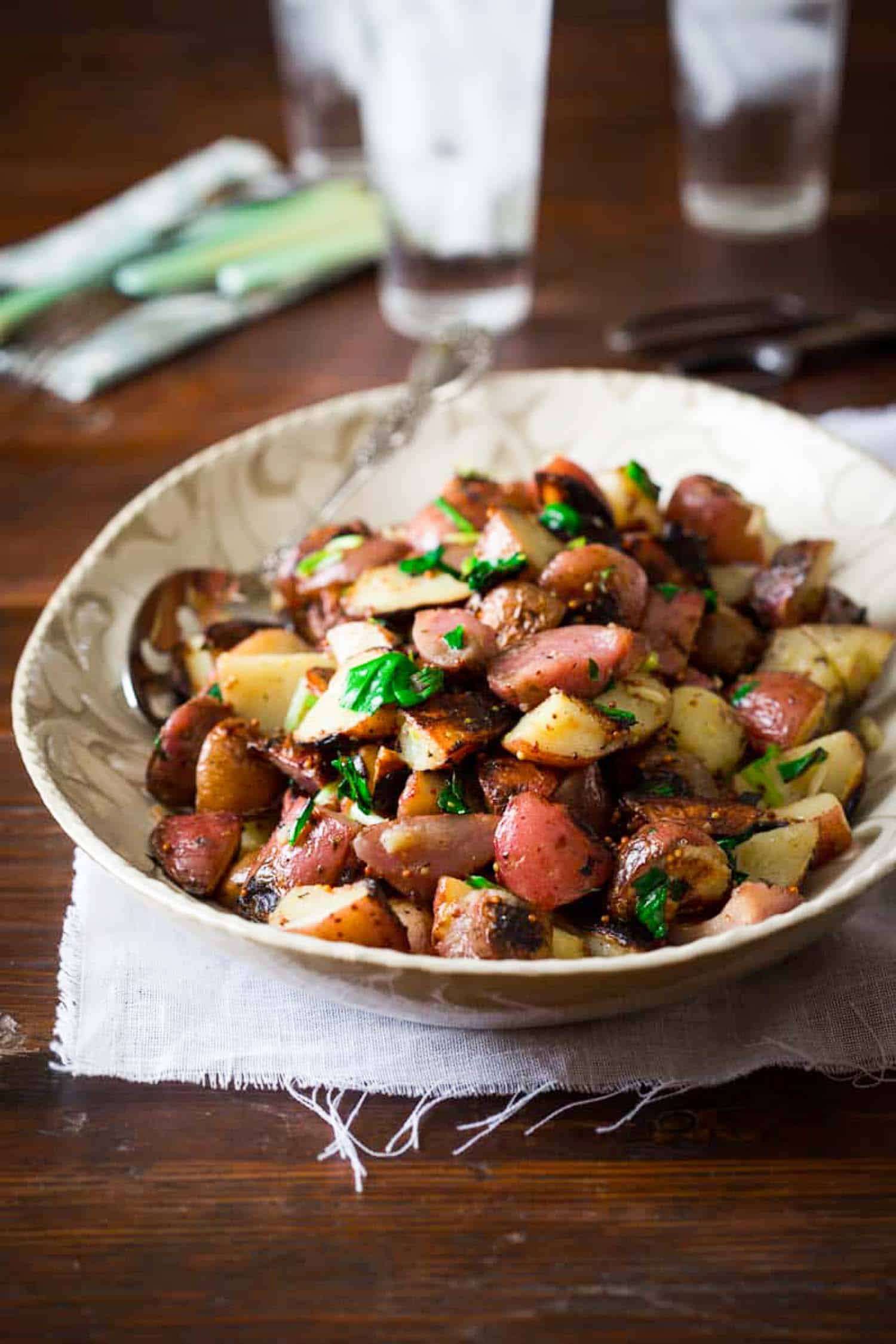 grilled potato salad with ramps in a bowl on a table