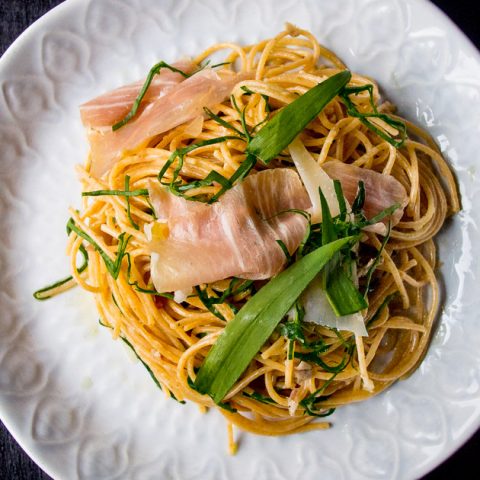 ramp pasta with prosciutto and parmesan on a white decorative plate