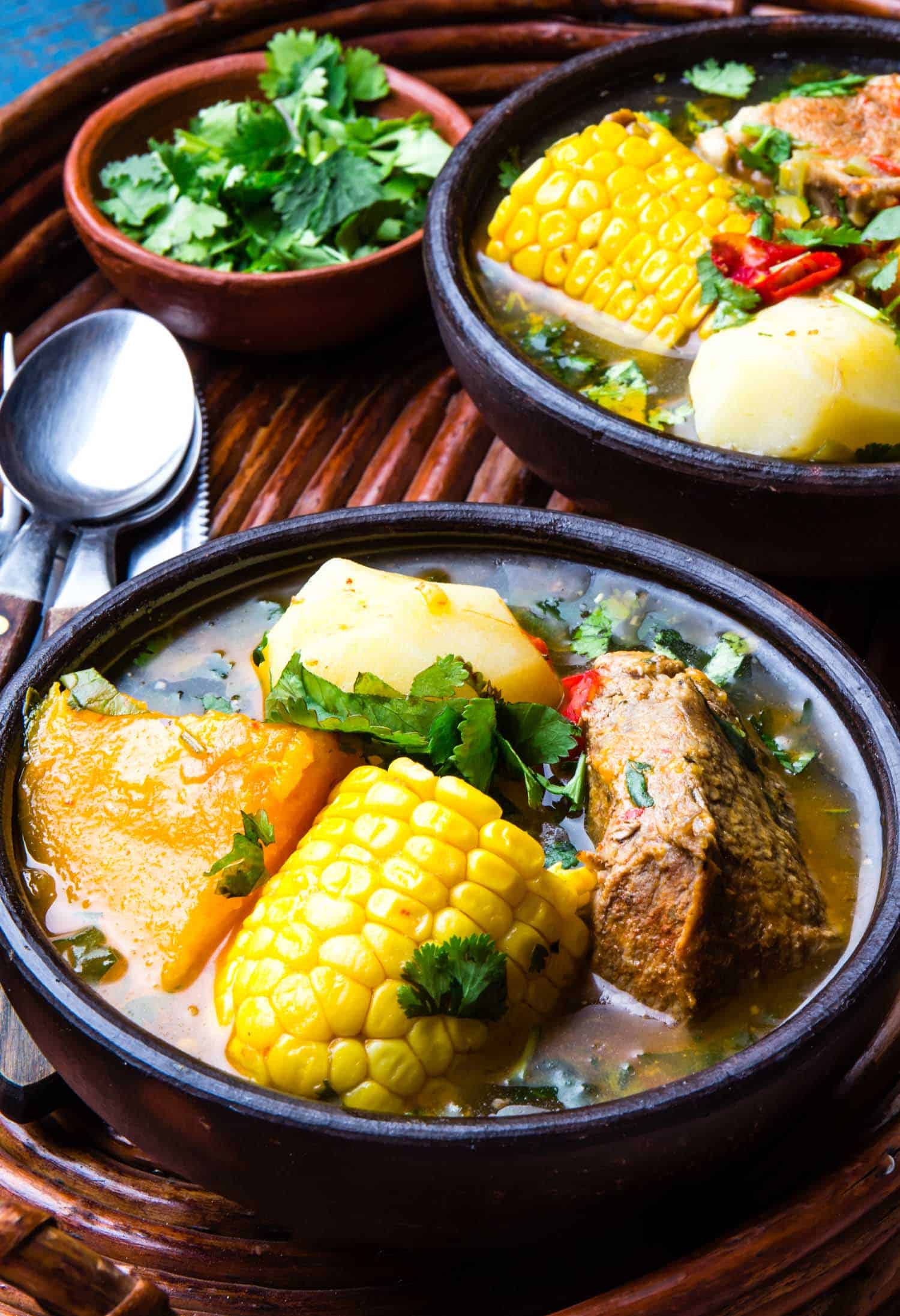 Latin American chilean food. Traditional chilean cazuela de cerdo with chuchoca. Pork soup with potatoes pumpkin. corn served in clay bowl from Pomaire.