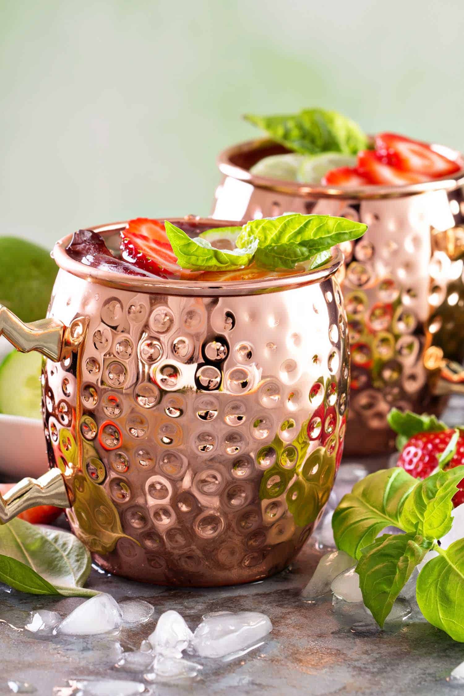 Moscow mule cocktail with lime, strawberry and basil