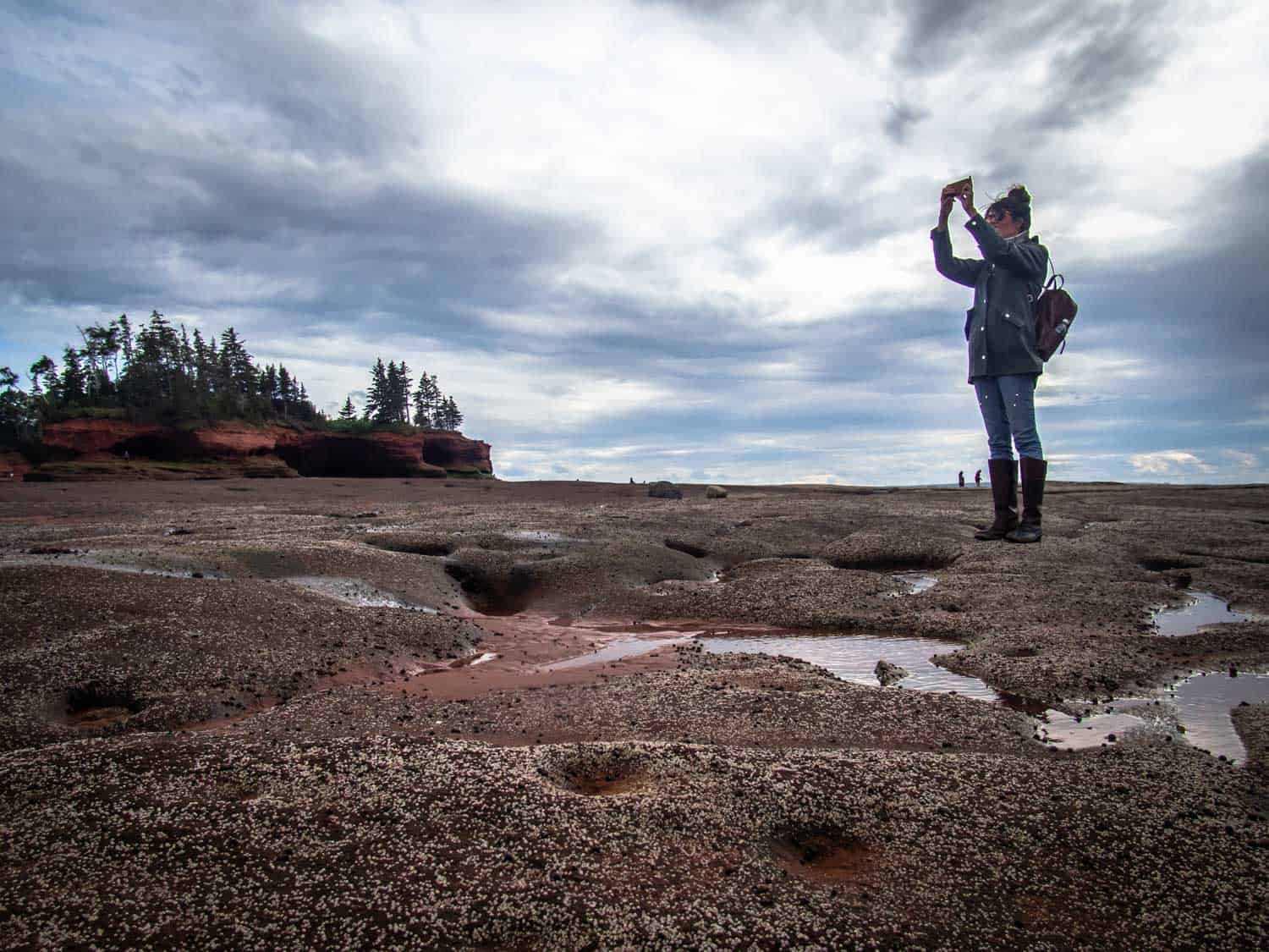 Person taking photo at Burntcoat Head Park in Nova Scotia