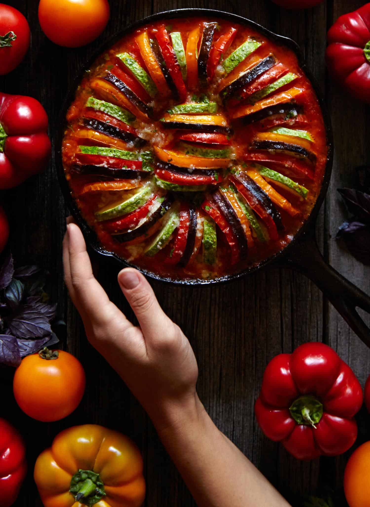 Ratatouille with peppers on black background.