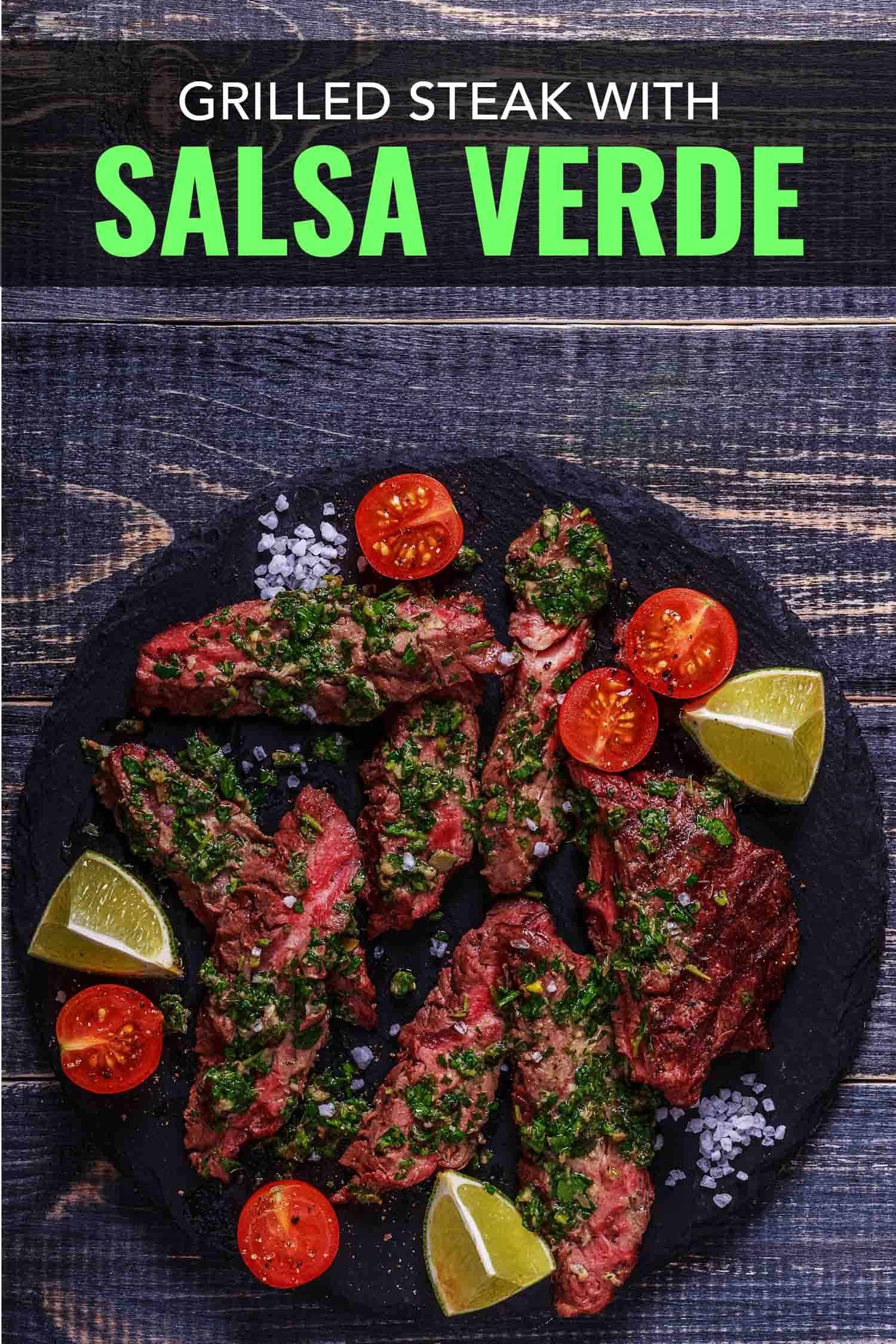 Grilled steak with salsa verde on a black plate